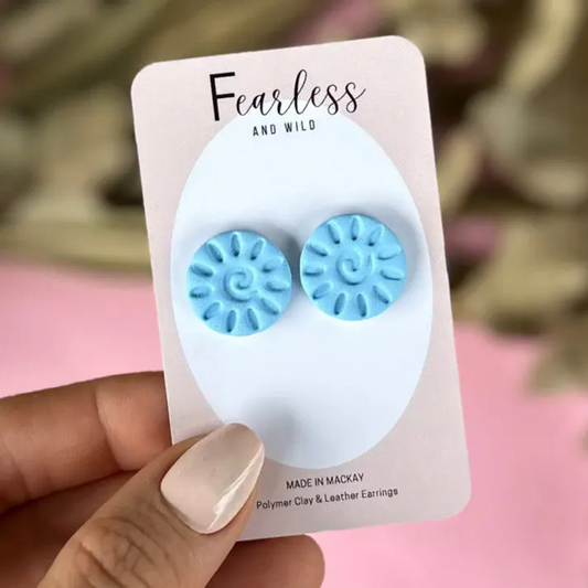 Light blue statement stud earrings with a unique pattern, handcrafted from polymer clay with stainless steel posts—bold, lightweight, and ideal for sensitive ears.
