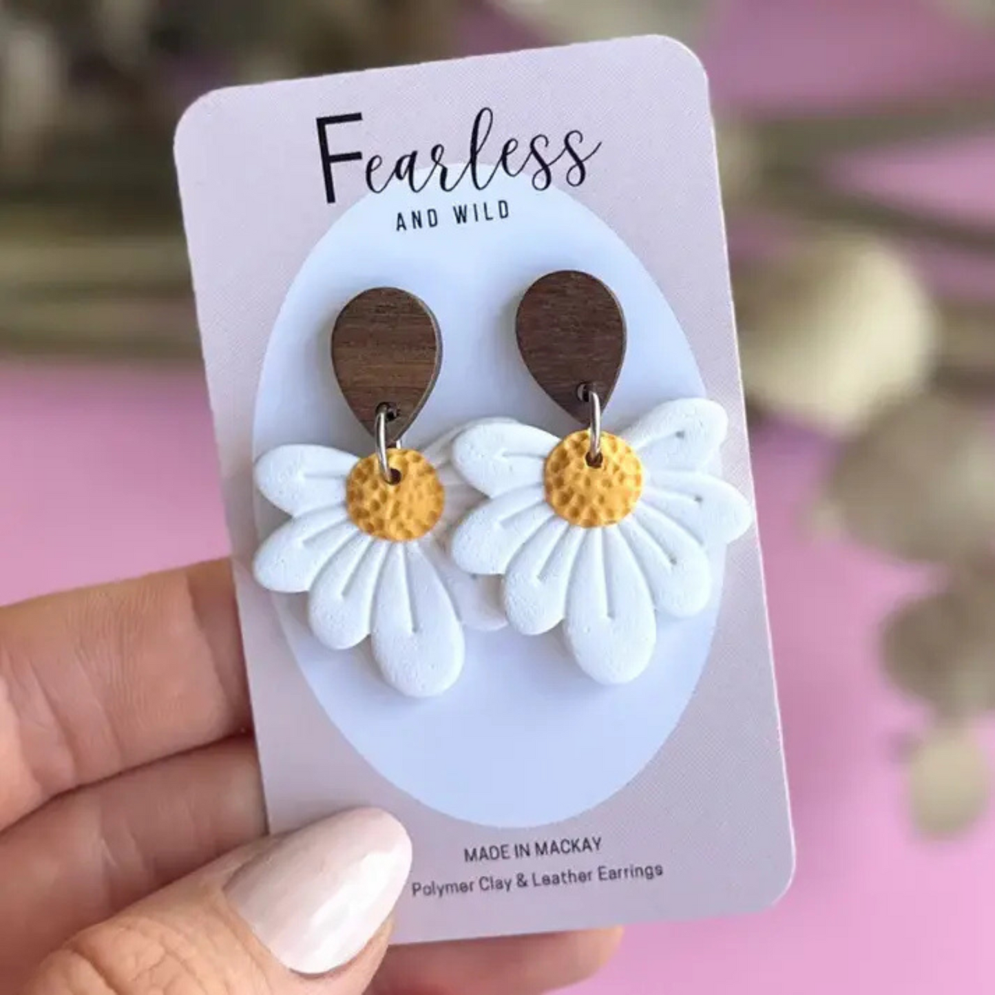 White daisy dangle earrings made from polymer clay with stainless steel posts, featuring a playful floral design—lightweight and ideal for sensitive ears.