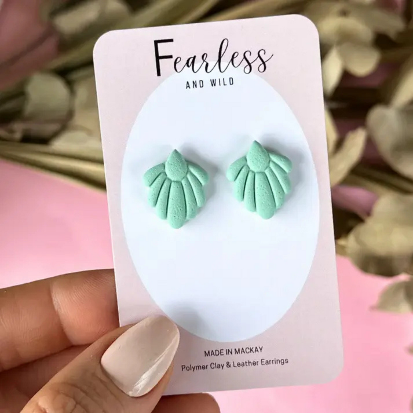 Sage green daisy petal stud earrings with a subtle Art Deco design, handcrafted from polymer clay with stainless steel posts—lightweight and ideal for sensitive ears.