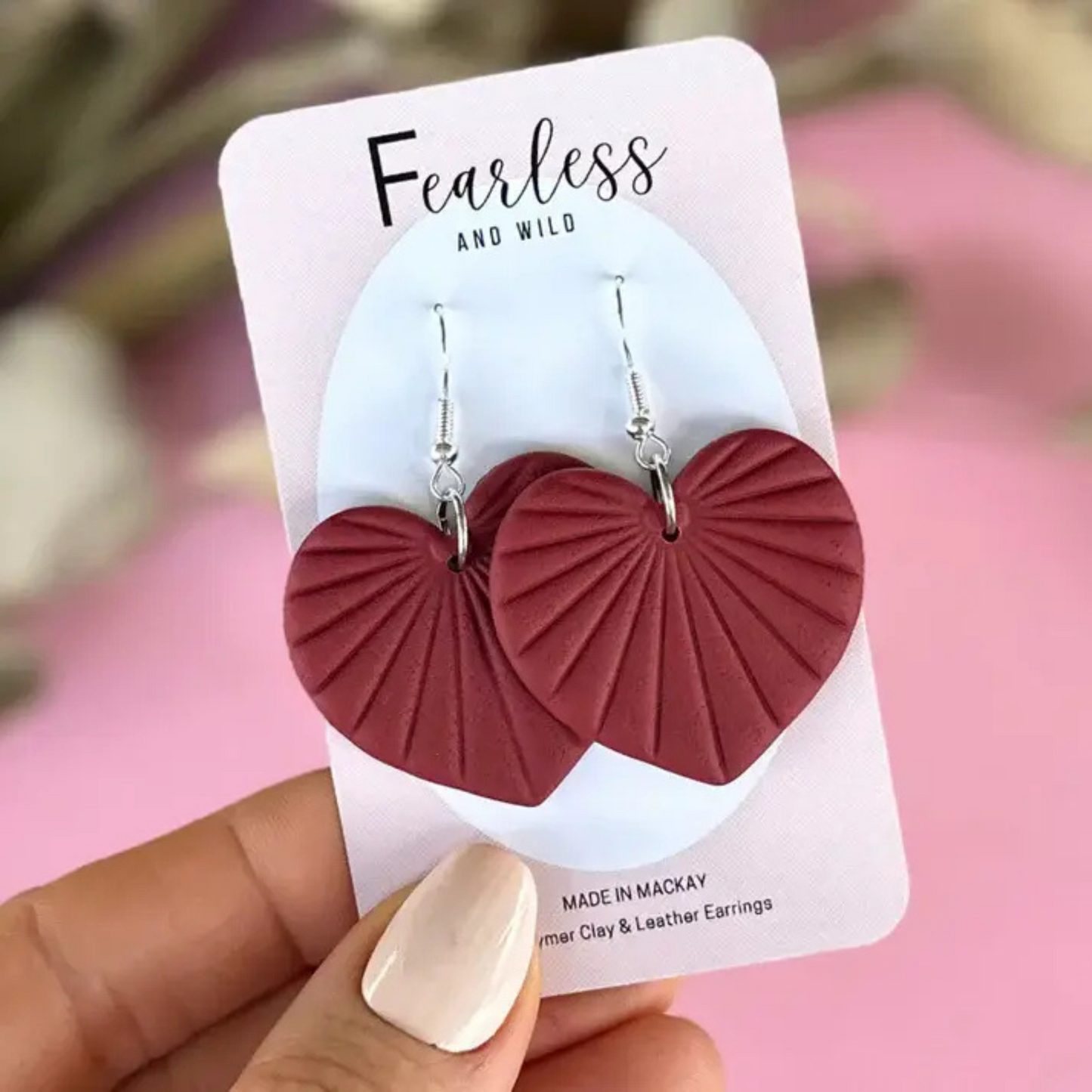 Handcrafted heart-shaped dangle earrings in rich burgundy polymer clay with stainless steel posts—lightweight, feminine, and perfect for sensitive ears.