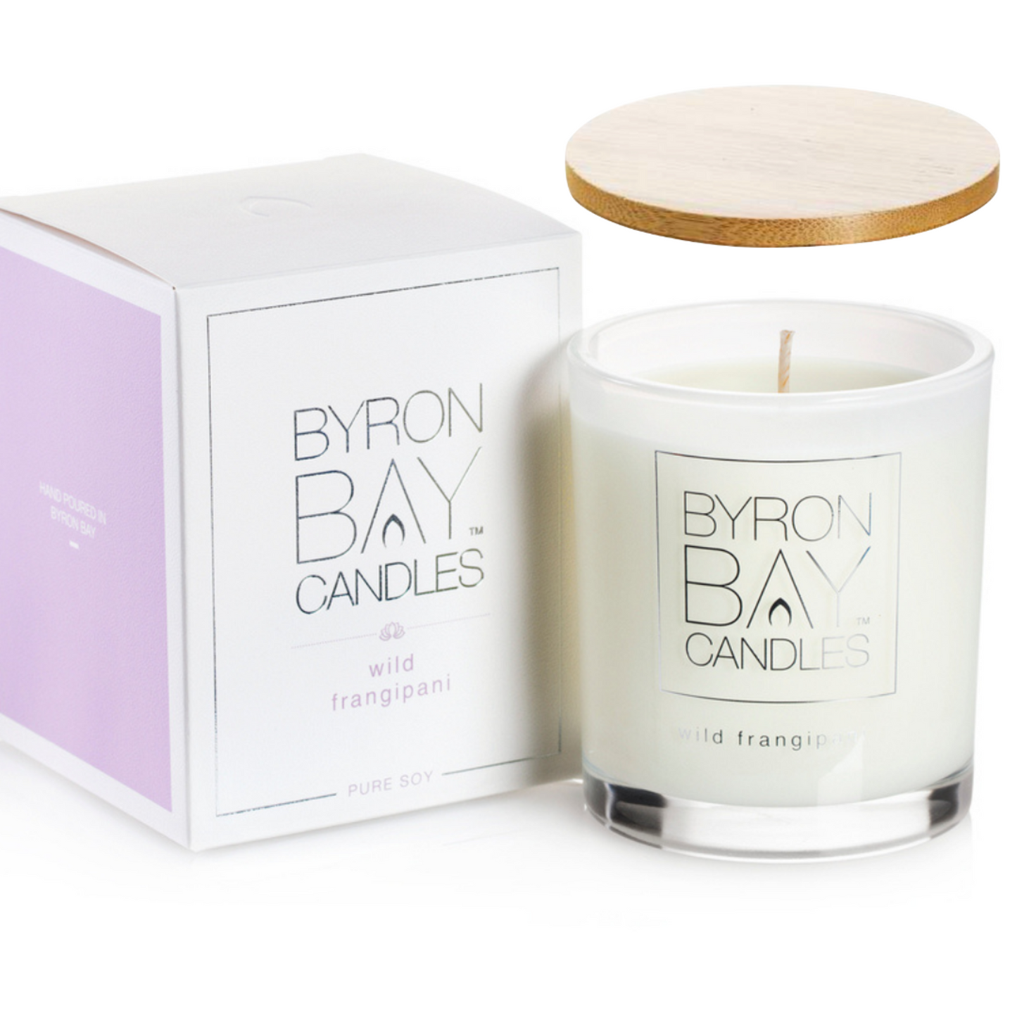 Wild Frangipani medium soy candle, 75x75x85mm jar in soft natural tones, hand-poured with 100% pure soy wax and cotton wick, offering 30+ hours burn time. Includes timber lid and gift box.