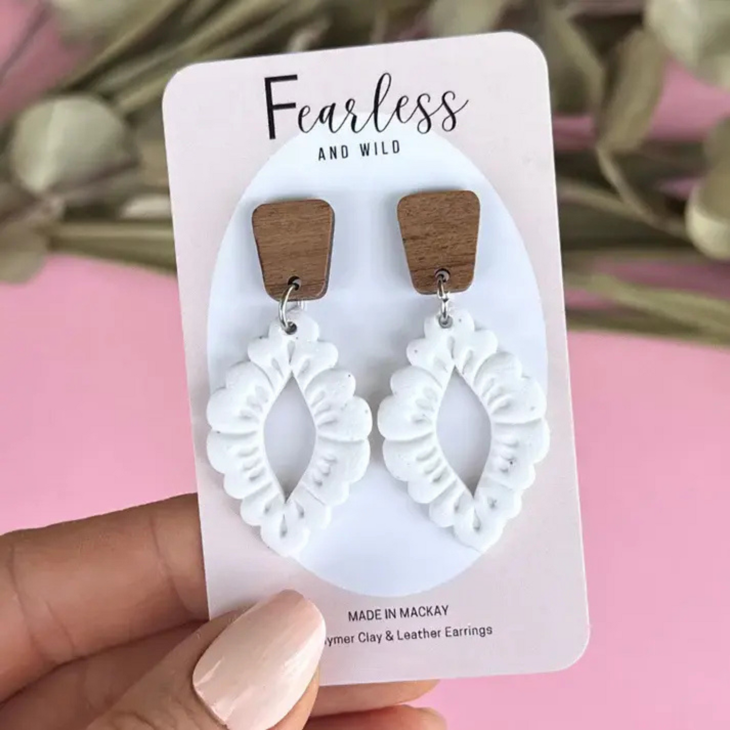 Handmade Wren White earrings featuring a mid-length design with white polymer clay flecked in granite, paired with a natural timber top and stainless steel posts.