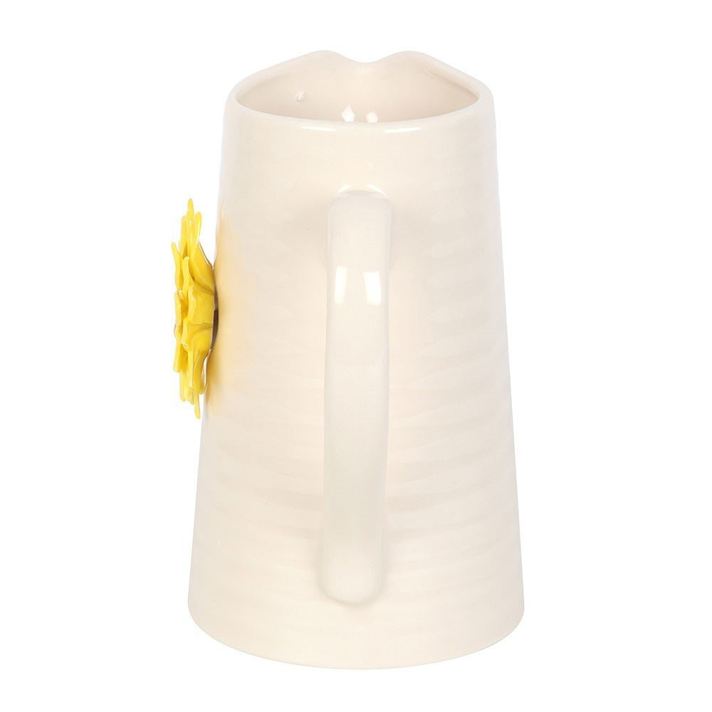 White jug with a yellow sunflower on a white background