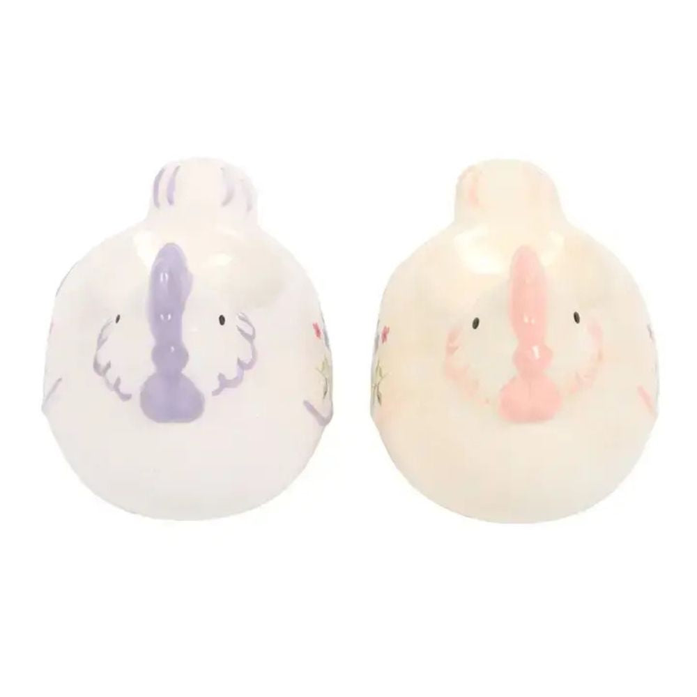 Two small chicken egg cups with floral designs on a white background