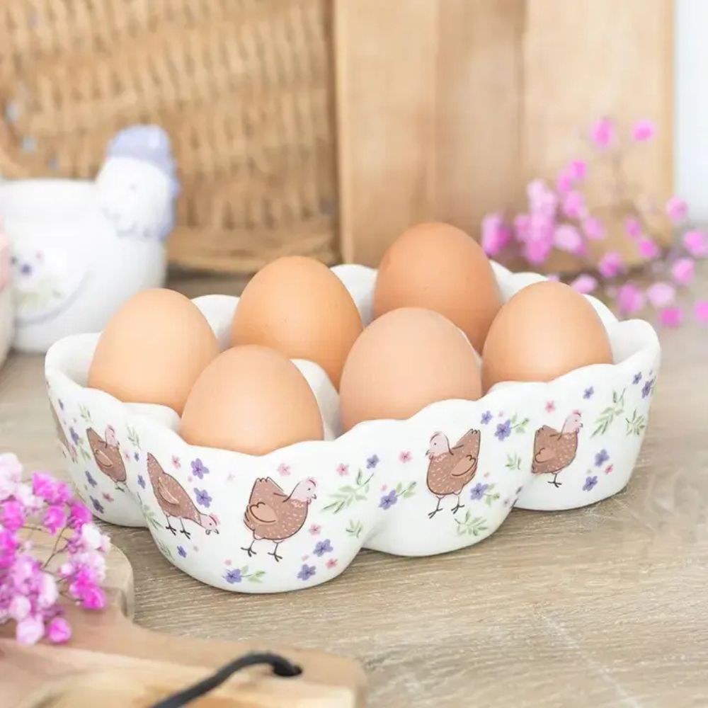 Decorative ceramic egg tray with eggs on a wooden surface