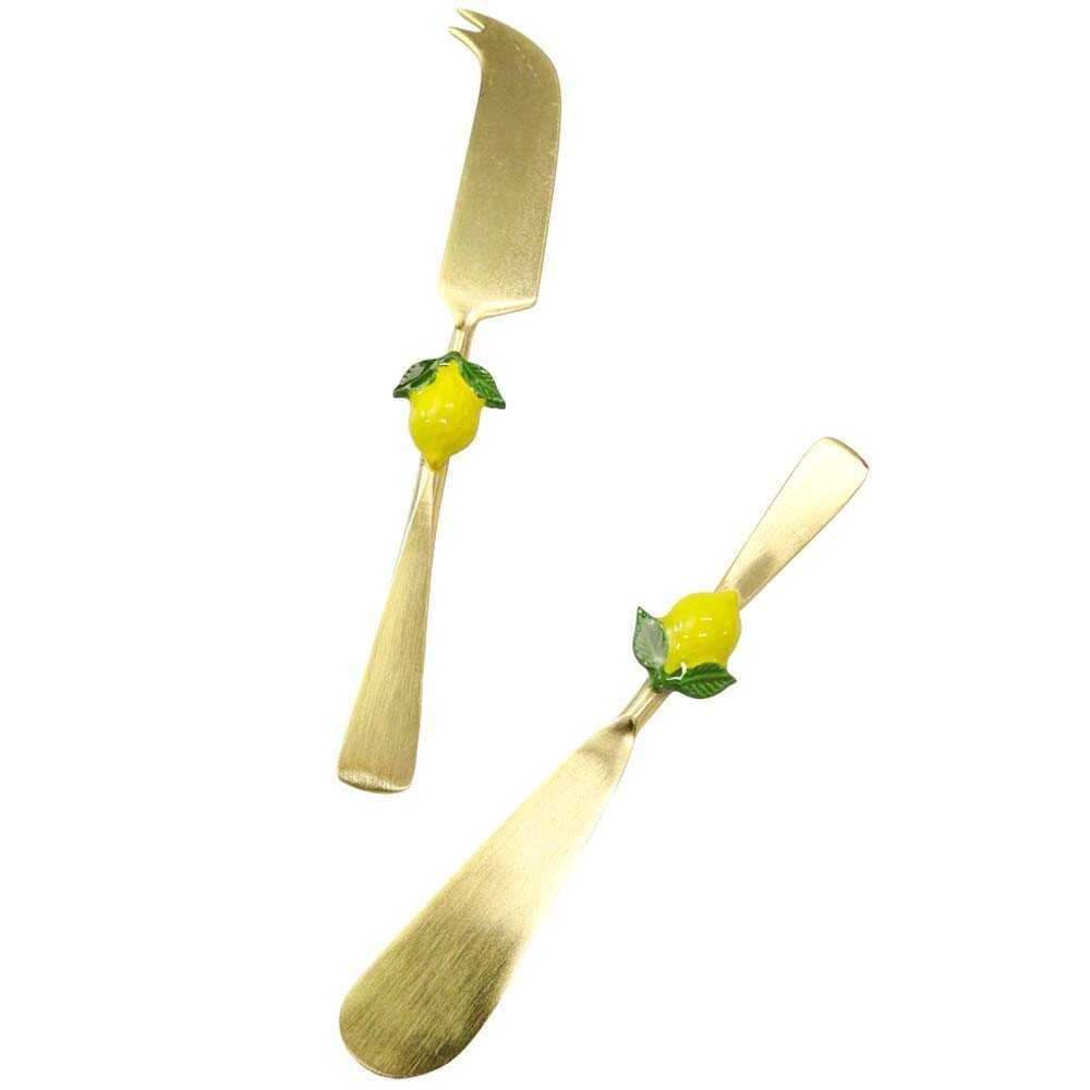 Gold spreader and cheese knife set with lemon decorations on a white background