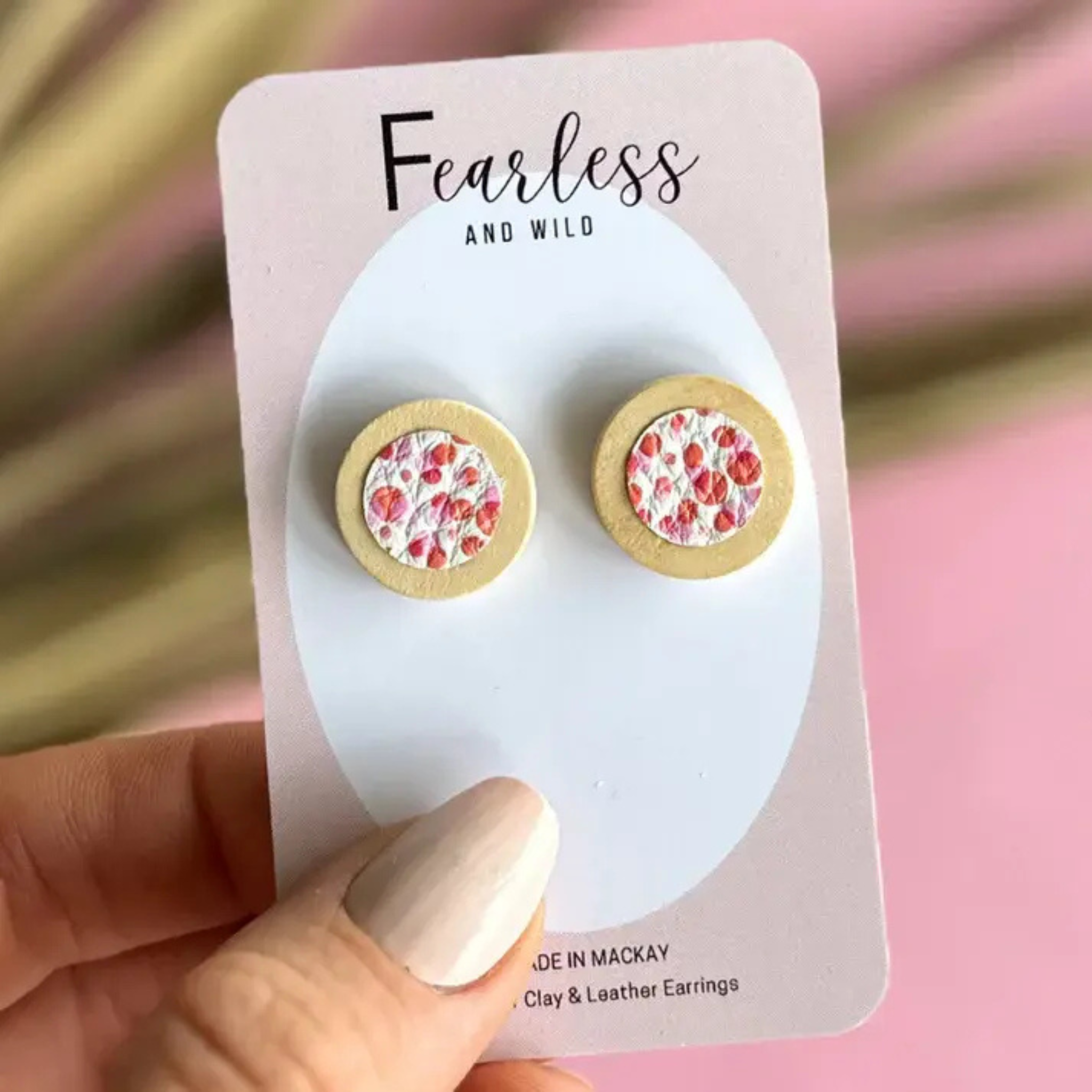 Melon-coloured round stud earrings with a timber cabochon, handcrafted from leather and wood with stainless steel posts—lightweight and ideal for sensitive ears.