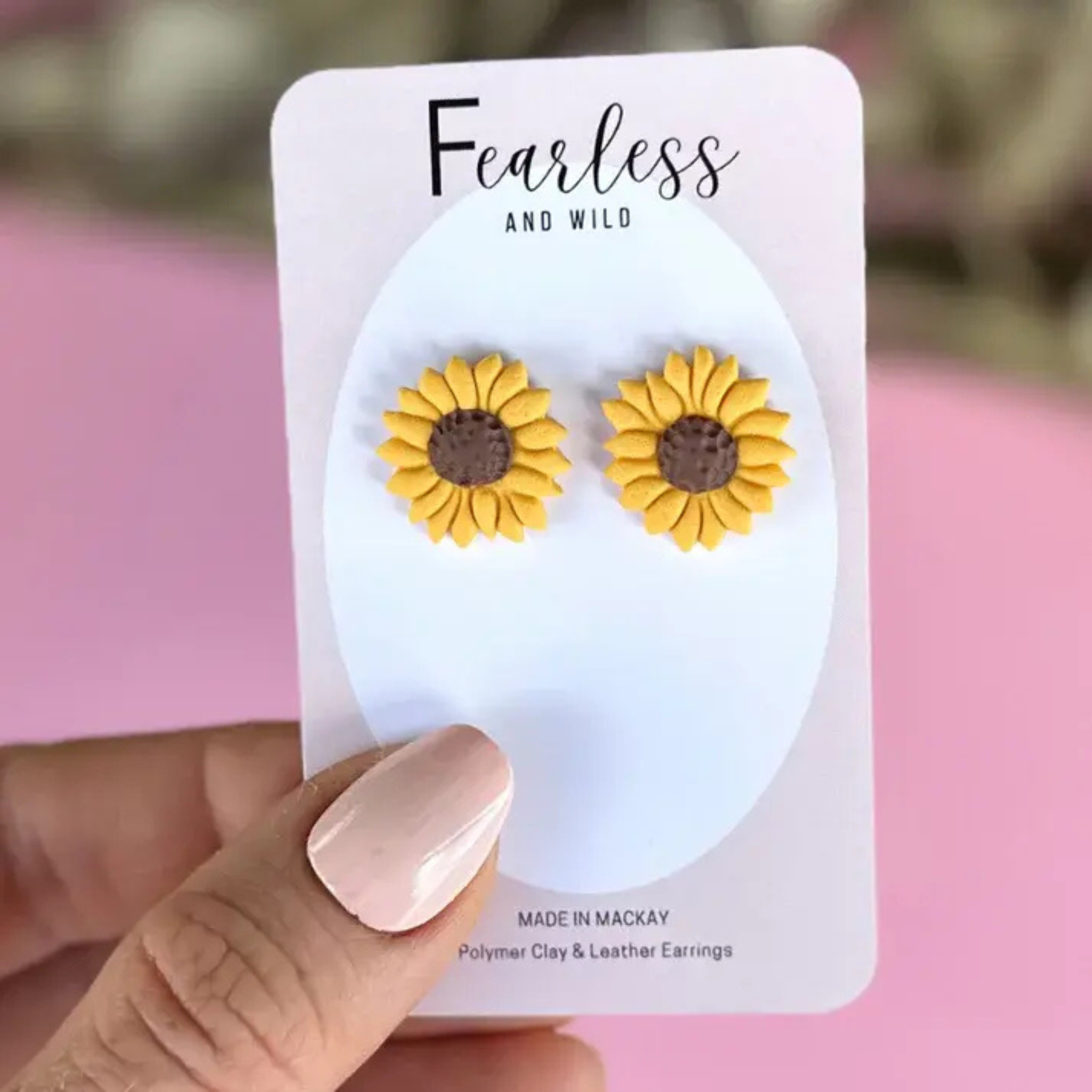 Close-up of cheerful yellow sunflower stud earrings made from polymer clay with a detailed sunflower design, featuring stainless steel posts for sensitive ears.