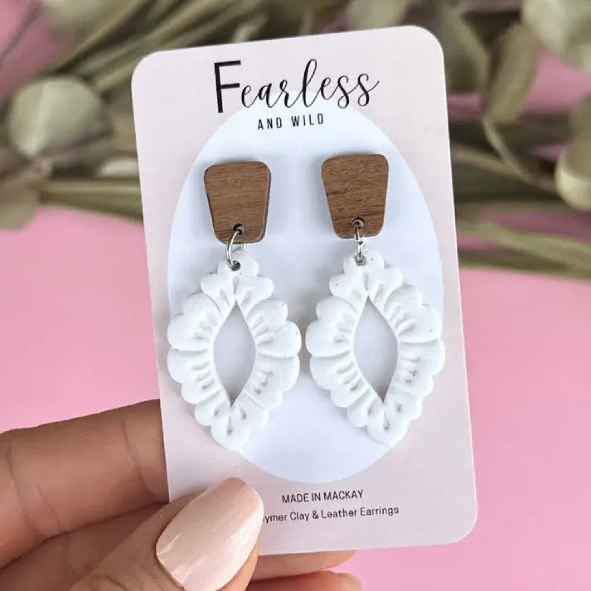 Handmade Wren White earrings featuring a mid-length design with white polymer clay flecked in granite, paired with a natural timber top and stainless steel posts.