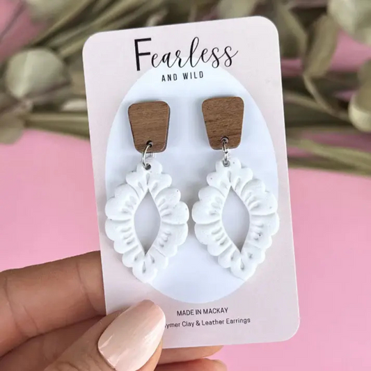 Handmade Wren White earrings featuring a mid-length design with white polymer clay flecked in granite, paired with a natural timber top and stainless steel posts.