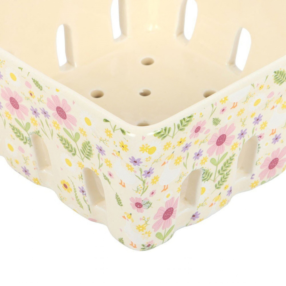 Decorative ceramic berry basket with floral pattern on a white background