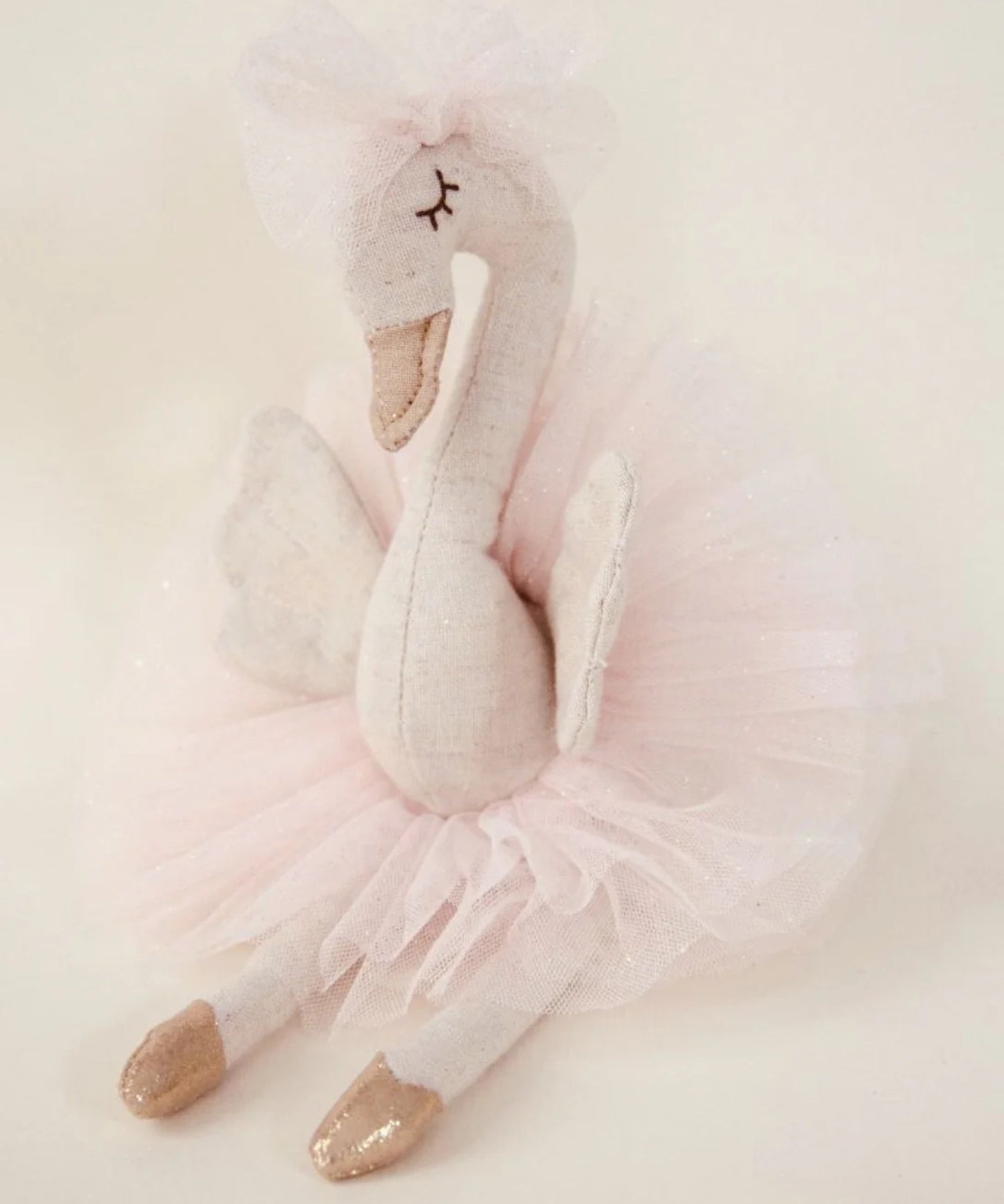 Odessa the Swan decorative figure, 28cm tall, made from linen with a soft tulle ballerina skirt, tulle bow, embroidered face, and gold ballet points.