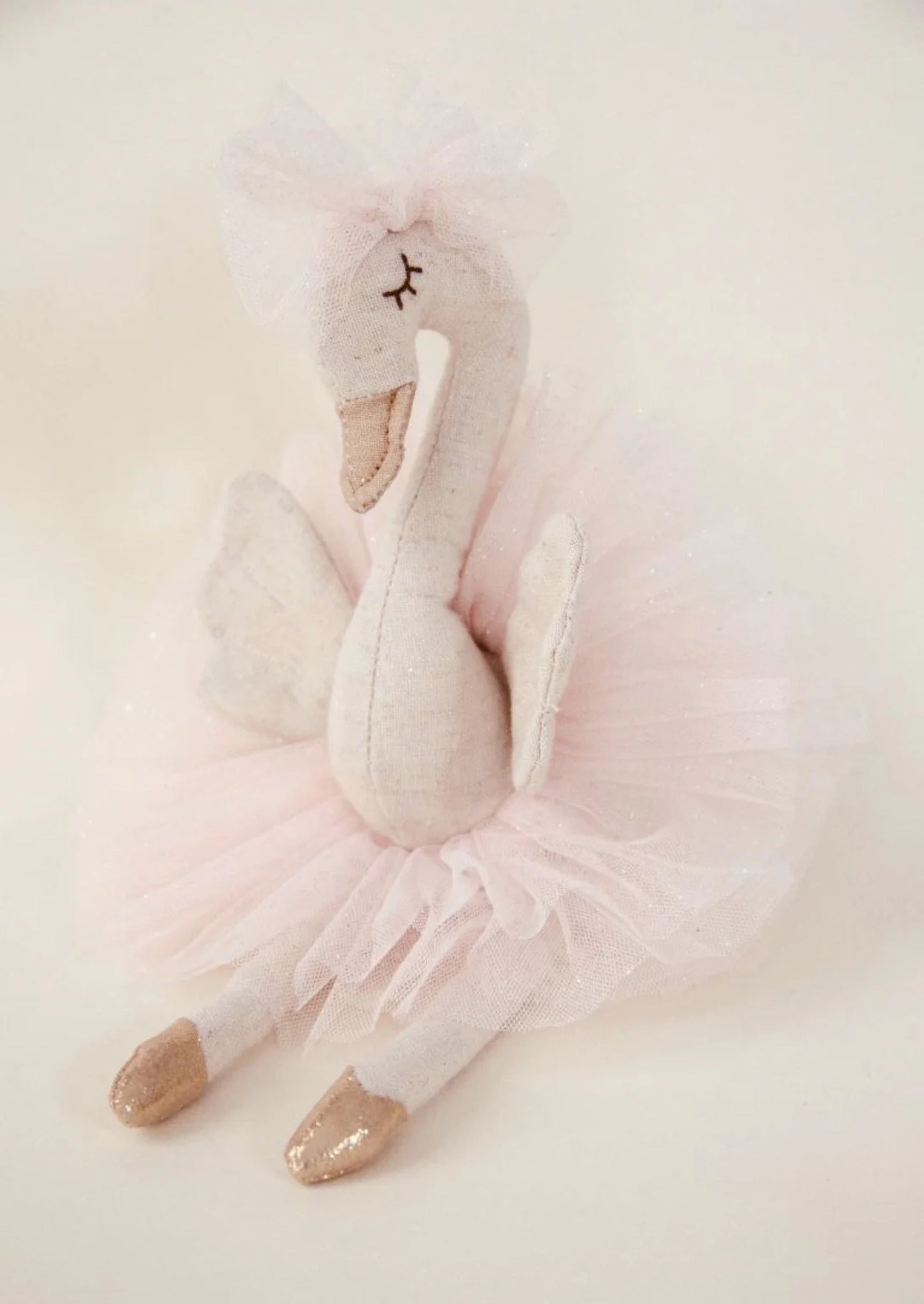Odessa the Swan decorative figure, 28cm tall, made from linen with a soft tulle ballerina skirt, tulle bow, embroidered face, and gold ballet points.